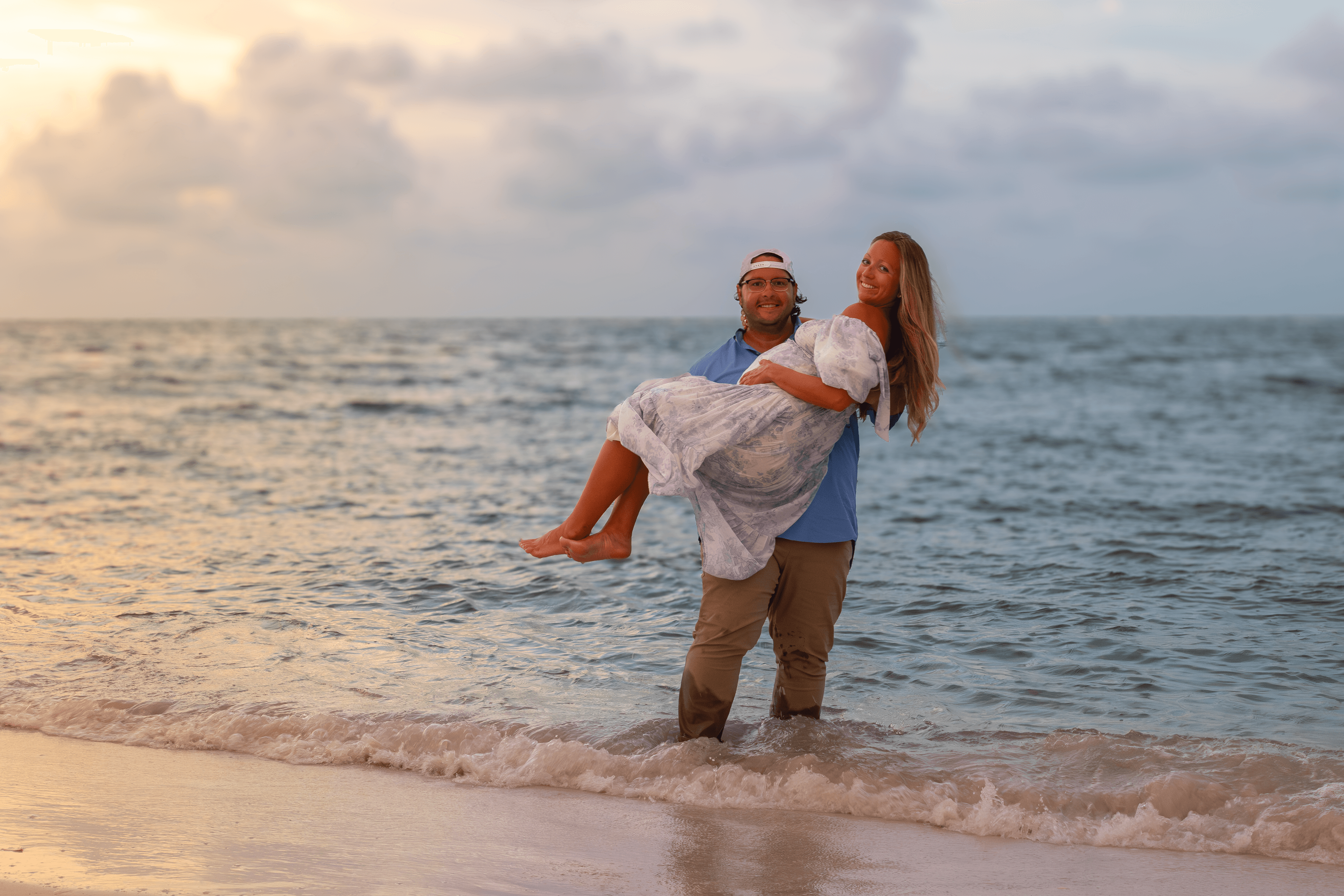Couple embracing in the dunes at dusk